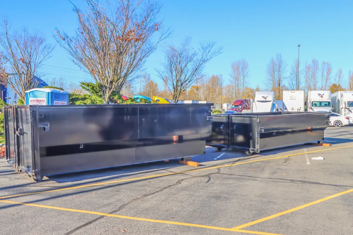 Professional dumpster rental service with roll-off container on residential driveway in Blacksburg